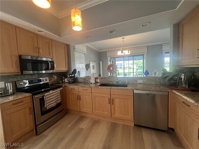 Kitchen with backsplash, appliances with stainless