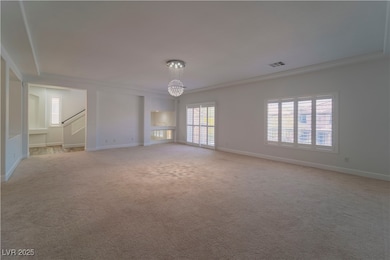 Unfurnished living room featuring a chandelier, li