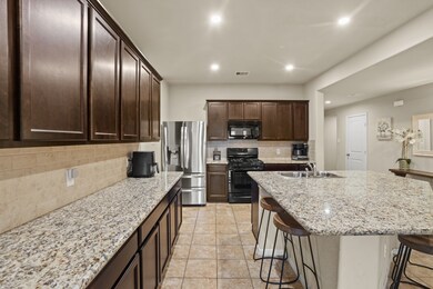 Granite countertops paired with a coordinating stone backsplash not only provide a durable and elegant surface for food preparation but also add a touch of luxury and sophistication to the kitchen.