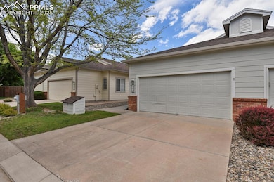 Single story home featuring brick siding, driveway, roof with shingles, and an attached garage
