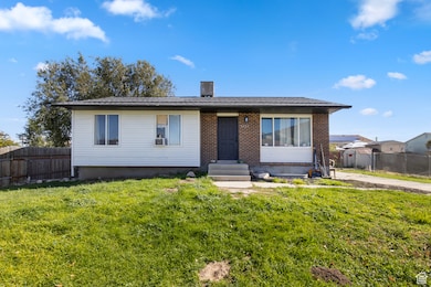 View of front facade with entry steps and brick siding