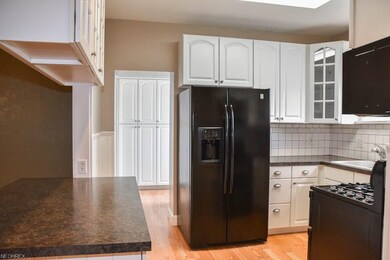 Beautiful white cabinets with a pantry down the ha