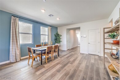 Photo is representational only; actual home finishes may vary. Dining area featuring light wood-style flooring and baseboards