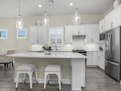 Fabulous open floor plan with sunroom...Kitchen is open and inviting, with plenty of storage, and is the perfect space for entertaining guests.