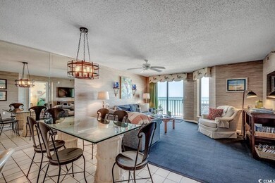 Kitchen with a textured ceiling, open floor plan, 