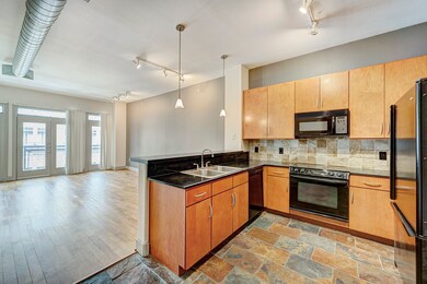 Striking kitchen with granite counter, appliances, slate flooring/backsplash and good cabinet space.
