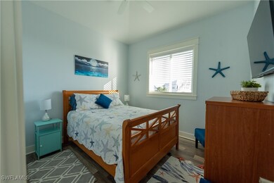 Bedroom with ceiling fan, baseboards, and wood fin
