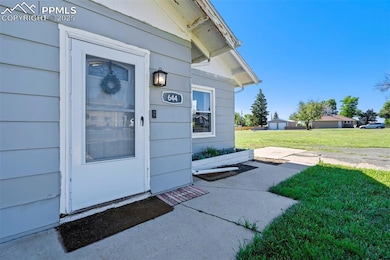 View of exterior entry with a yard