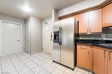 Kitchen featuring stainless steel fridge, light ti