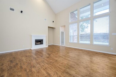 Living room features soaring ceiling and gas log f