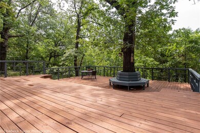 The deck will make any entertainer proud and even boasts a custom bench surrounding a mature tree!