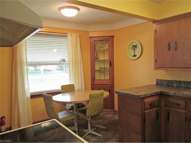 Dining area open to the kitchen with two built-ins