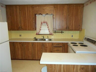 Kitchen: Room features include vinyl flooring for easy cleaning, two windows for natural light. Note also that here you have a window over the sink that allows you to look out and see what is going on outside as you are cleaning up after a nice family diner. Also note that both the stove and refrigerator stay with the home at closing.