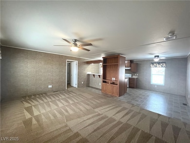  Living room w/ceiling fan & light, carpet & built in entertainment center.