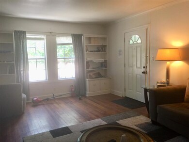 Foyer with ornamental molding, baseboards, and wo