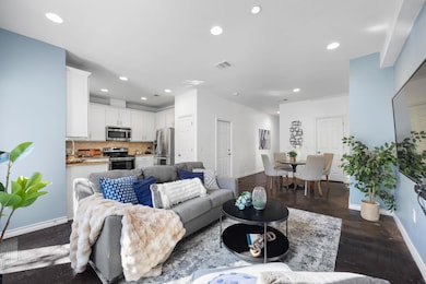 Living area with recessed lighting and dark wood-type flooring