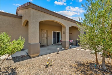 View of exterior entry with stucco siding and a pa