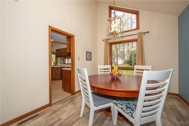 Dining area with LVT floor is also vaulted and ful