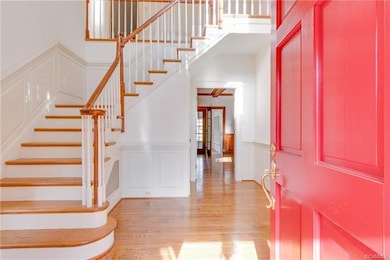 Dramatic entry hall with turned staircase, all har