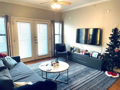 Living area featuring french doors, ceiling fan, 