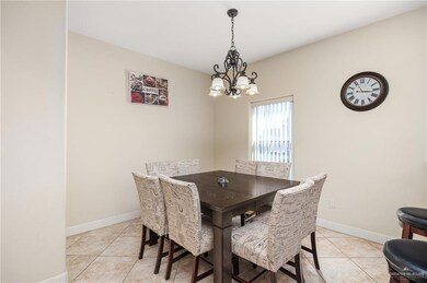 Tiled dining area with a chandelier