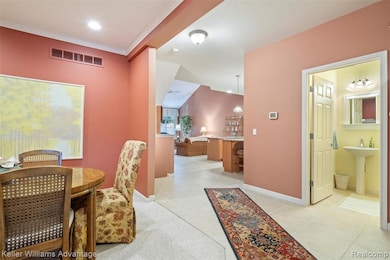 Dining space with ornamental molding and light tile patterned floors