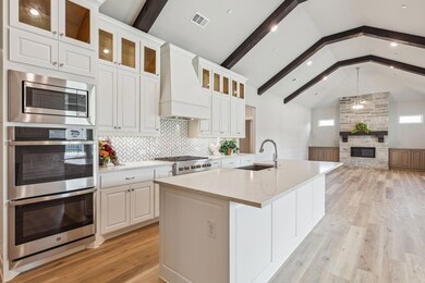 Kitchen featuring sink, vaulted ceiling with beams