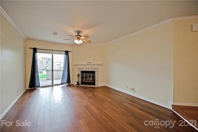 Great Room features tile surround, wood burning fireplace, ceiling fan w/light, bamboo flooring & patio access!