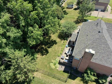 Enjoy this large tree lined lot with wrought iron 