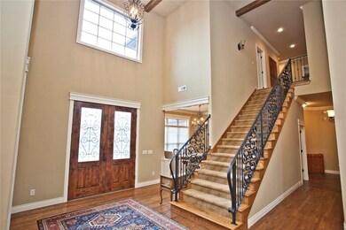 Open entry with beautiful iron work and cathedral ceilings