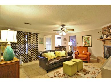 Photo. Large den with wood burning fireplace.