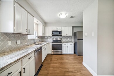 Nice open kitchen with updated counters and backsplash
