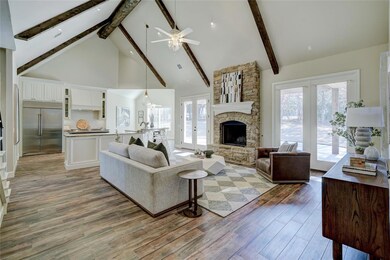 Living room featuring high vaulted ceiling, light 