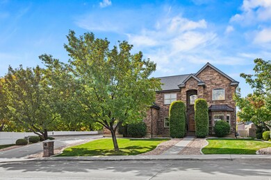 View of front of house featuring stone siding and a standing seam roof
