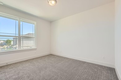 Carpeted spare room with baseboards
