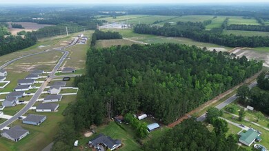 Aerial view of property and surrounding area featuring rural landscape