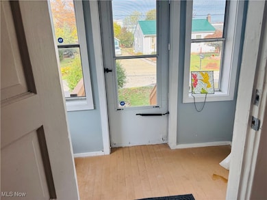 Entryway with hardwood / wood-style flooring and healthy amount of natural light