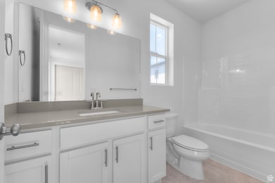 Bathroom featuring vanity and shower / bath combination