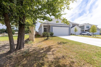 View of front of house featuring concrete driveway, a front lawn, a garage, and board and batten siding