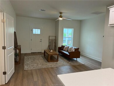 Living area featuring wood finished floors and cei