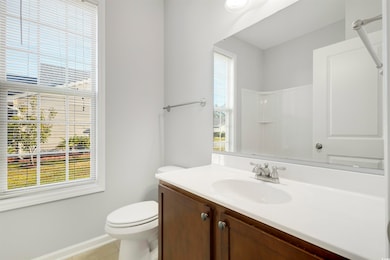 Bathroom with vanity, toilet, tile patterned floor