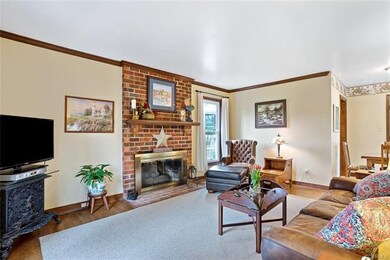 Inviting family room features brick fireplace with