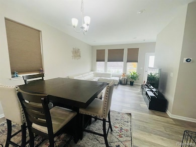 Dining space featuring light wood-type flooring and a chandelier