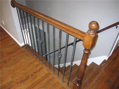 Hardwood floors and stairs with wrought iron spind