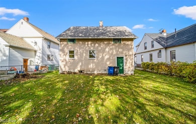 Back of house featuring a fenced backyard and a chimney