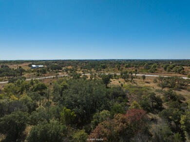 Aerial view of property's location featuring a heavily wooded area