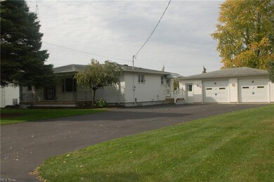 View of front facade featuring a front yard and a garage