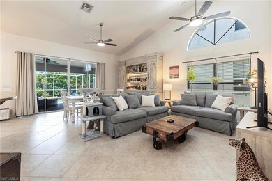 Living room featuring ceiling fan, high vaulted ceiling, and light tile on a diagonal