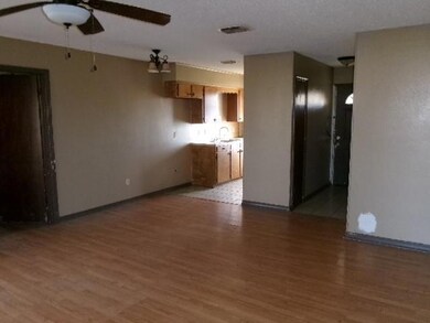 Unfurnished living room with a sink, visible vents