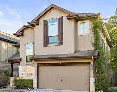 View of front of house with a garage, a shingled 